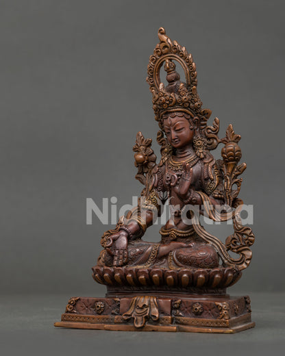 Detailed White Tara statue with hand-carved floral robe and lotus flowers.