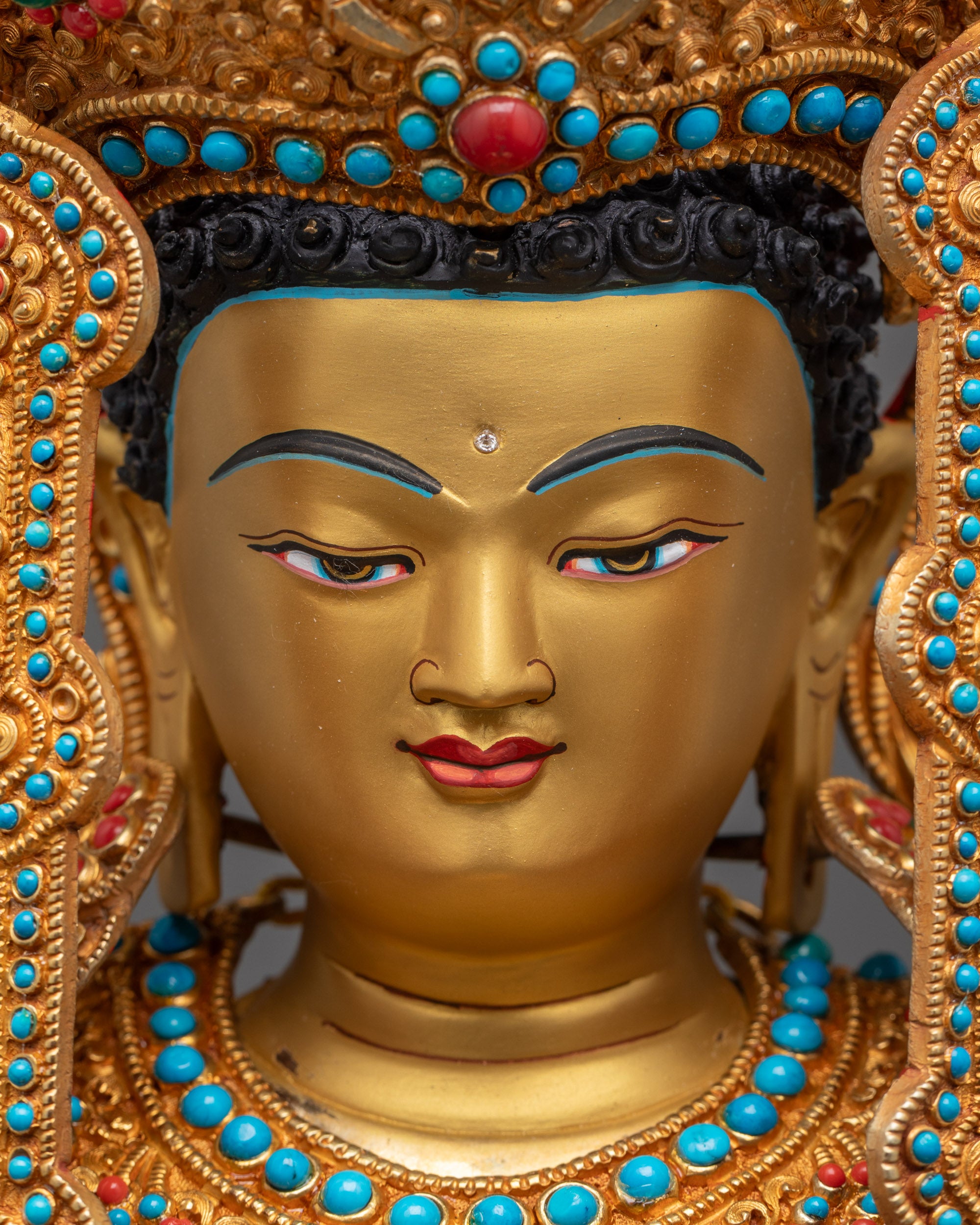 detailed close up face Jowo Shakyamuni Buddha showing serene gold gilded face and jeweled crown