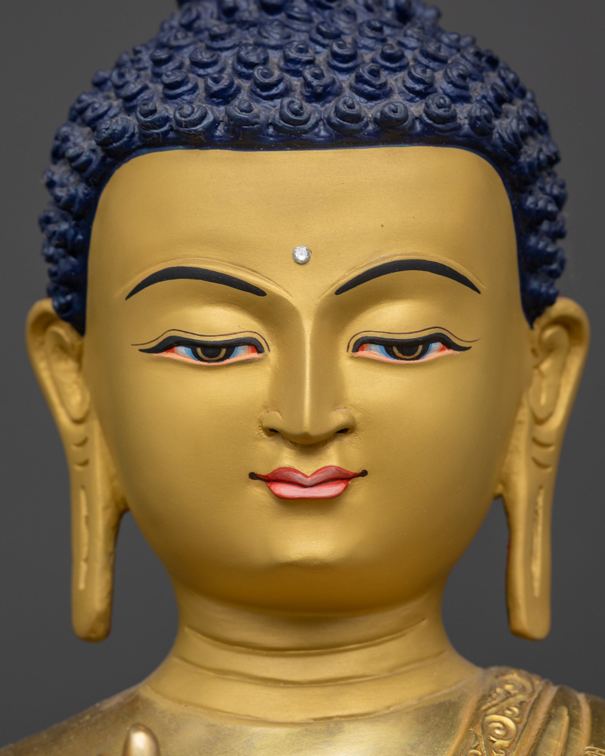 detailed close up face amoghasiddhi buddha statue radiant gold gilded serene expression

