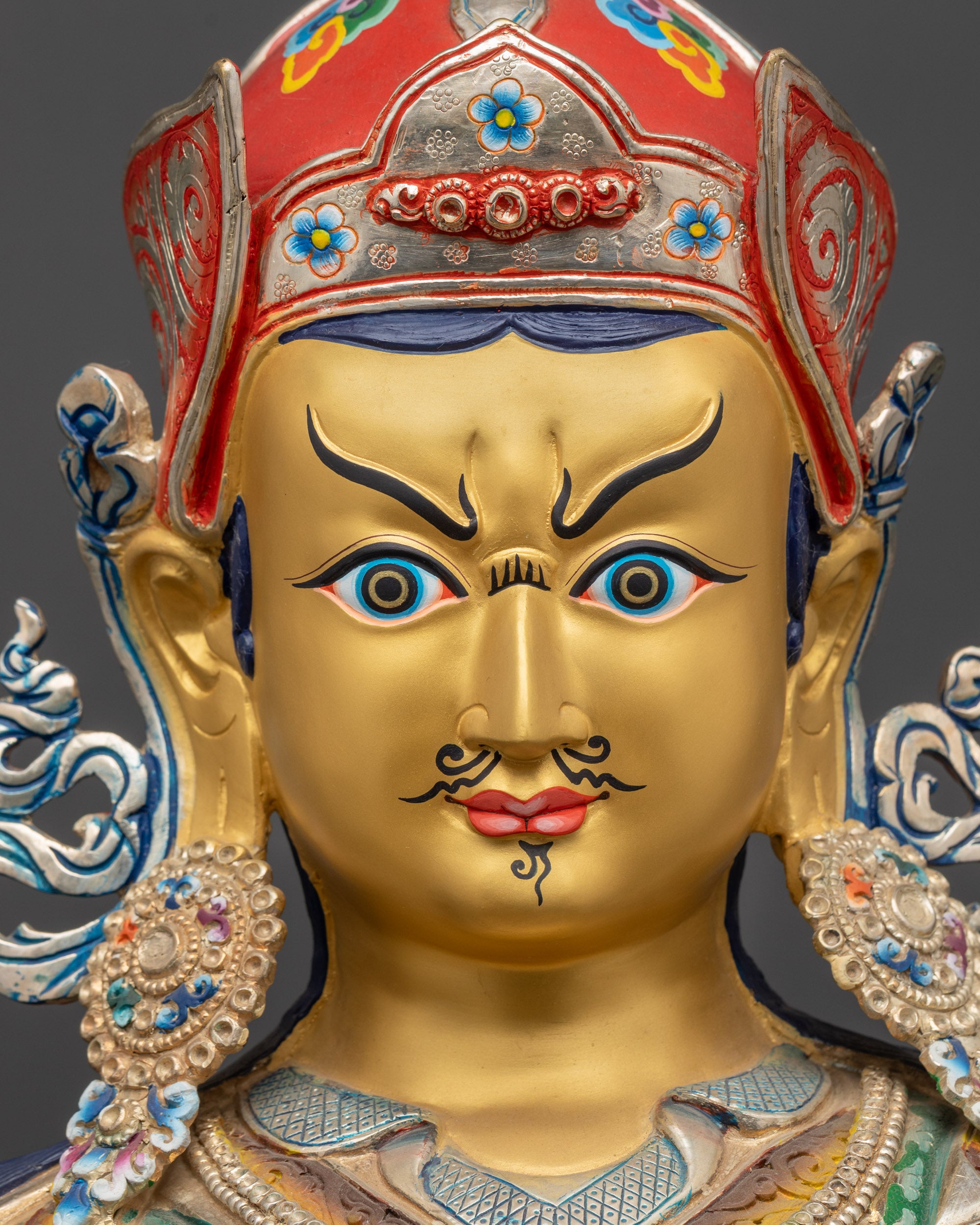 detailed close up face of Guru Rinpoche Statue with 24K gold gilding and vivid acrylic paint