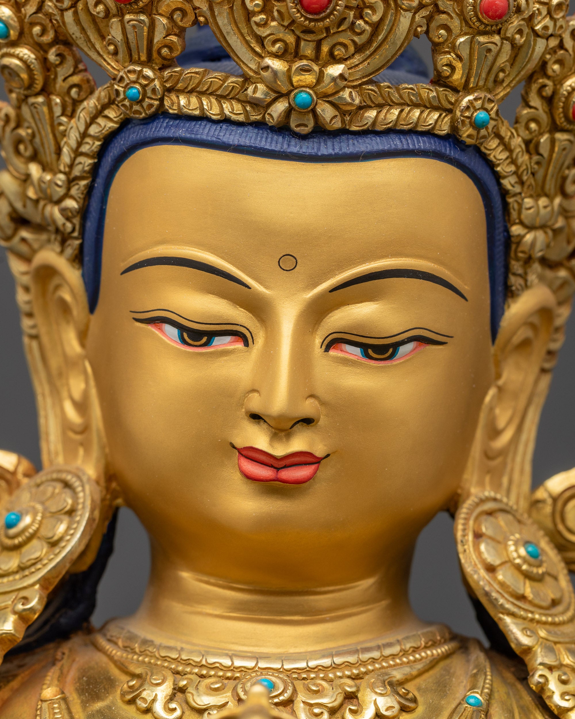 detailed close up face of Vajrasattva Statue with serene expression and crown
