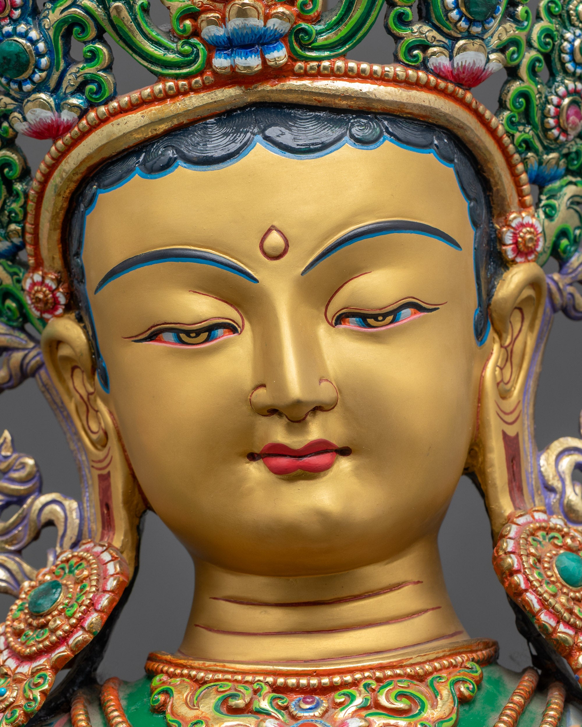 detailed close up of gold-gilded face of Divine Green Tara Statue