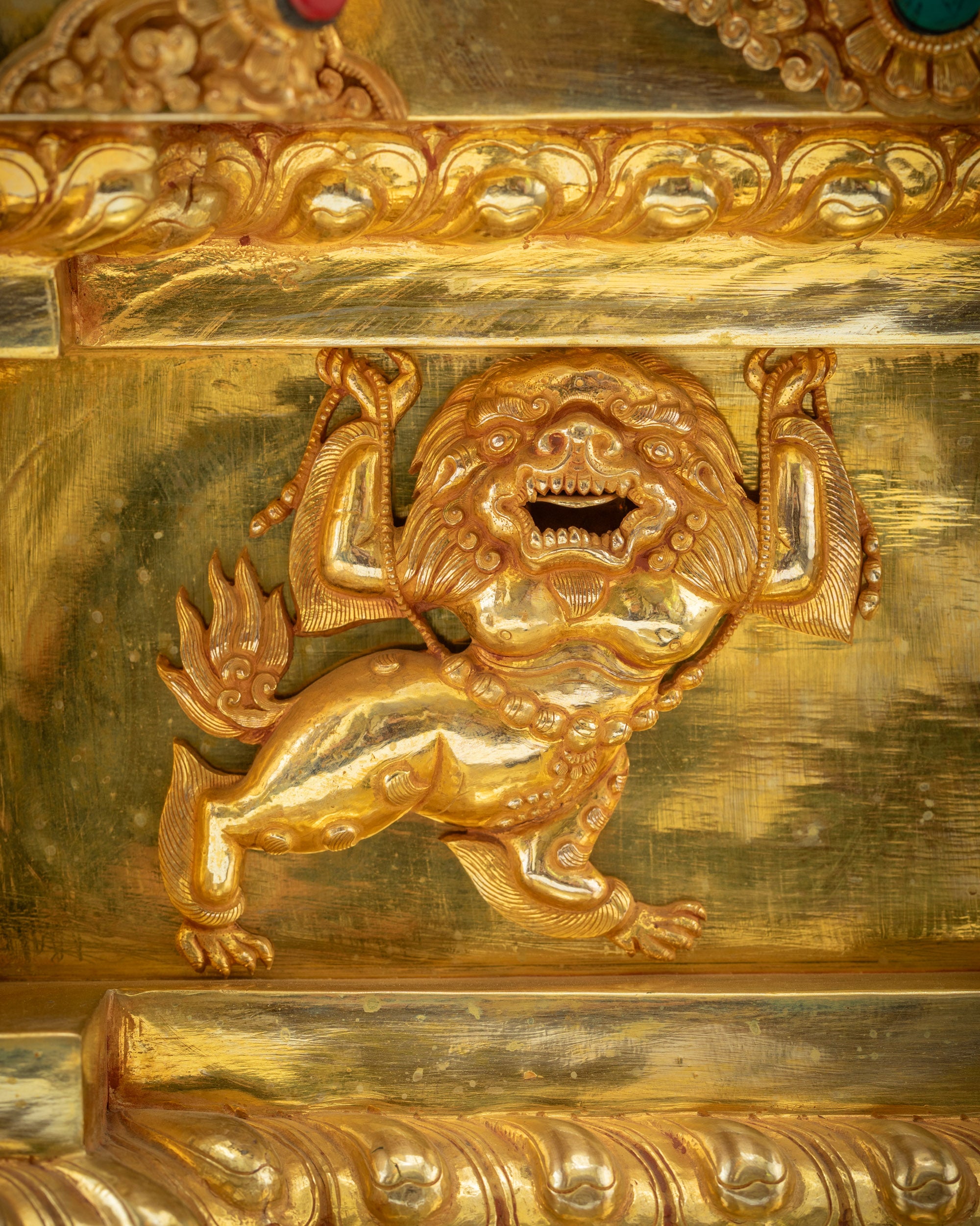 detailed lion-supported base of Buddhist deity throne with stone inlay border
