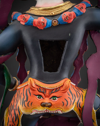 detailed robe back view Simha Mukha statue highlighting tiger-skin and flowing robe
