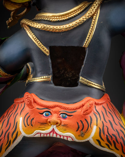 detailed robe back view Vajrapani statue highlighting swirling tiger-skin and flame motifs
