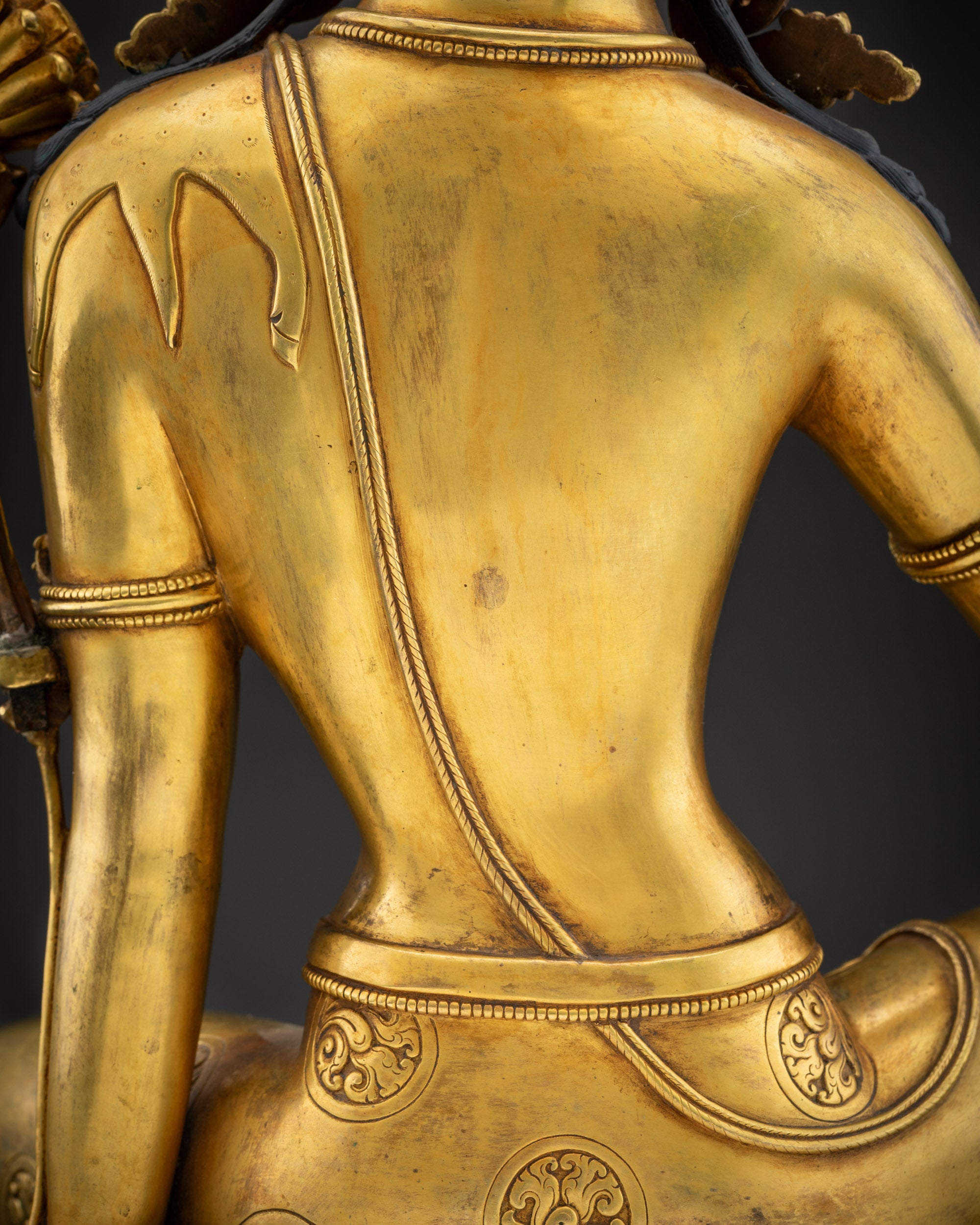 detailed robe back view chenrezig statue with ornate patterns and filigree