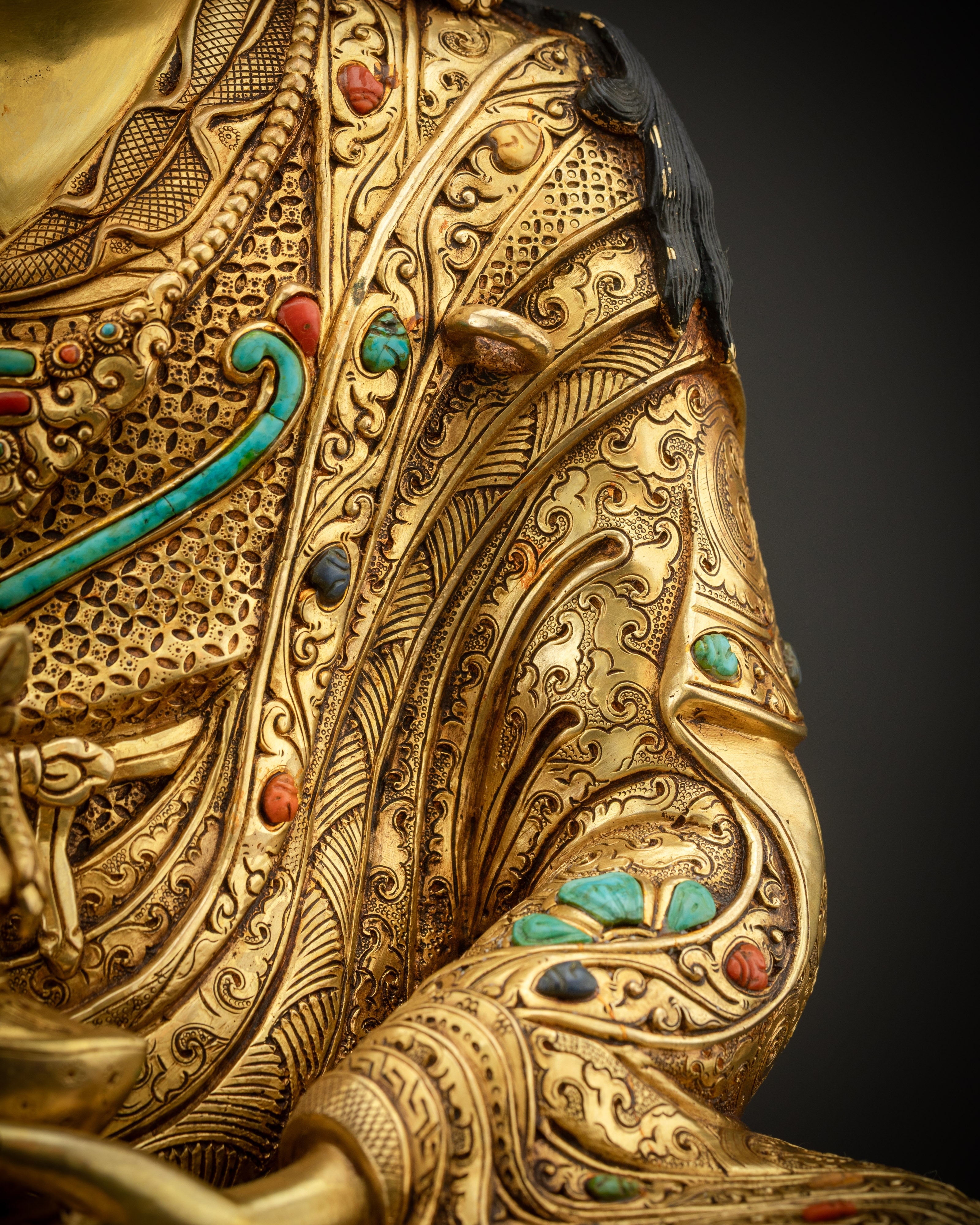 detailed shot of robe and stones Padmasambhava statue semi precious stones Nepal art

