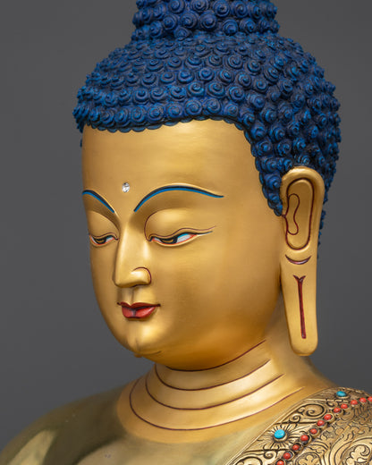 detailed side close up of Medicine Buddha Statue with gold-gilded halo and intricate robe details
