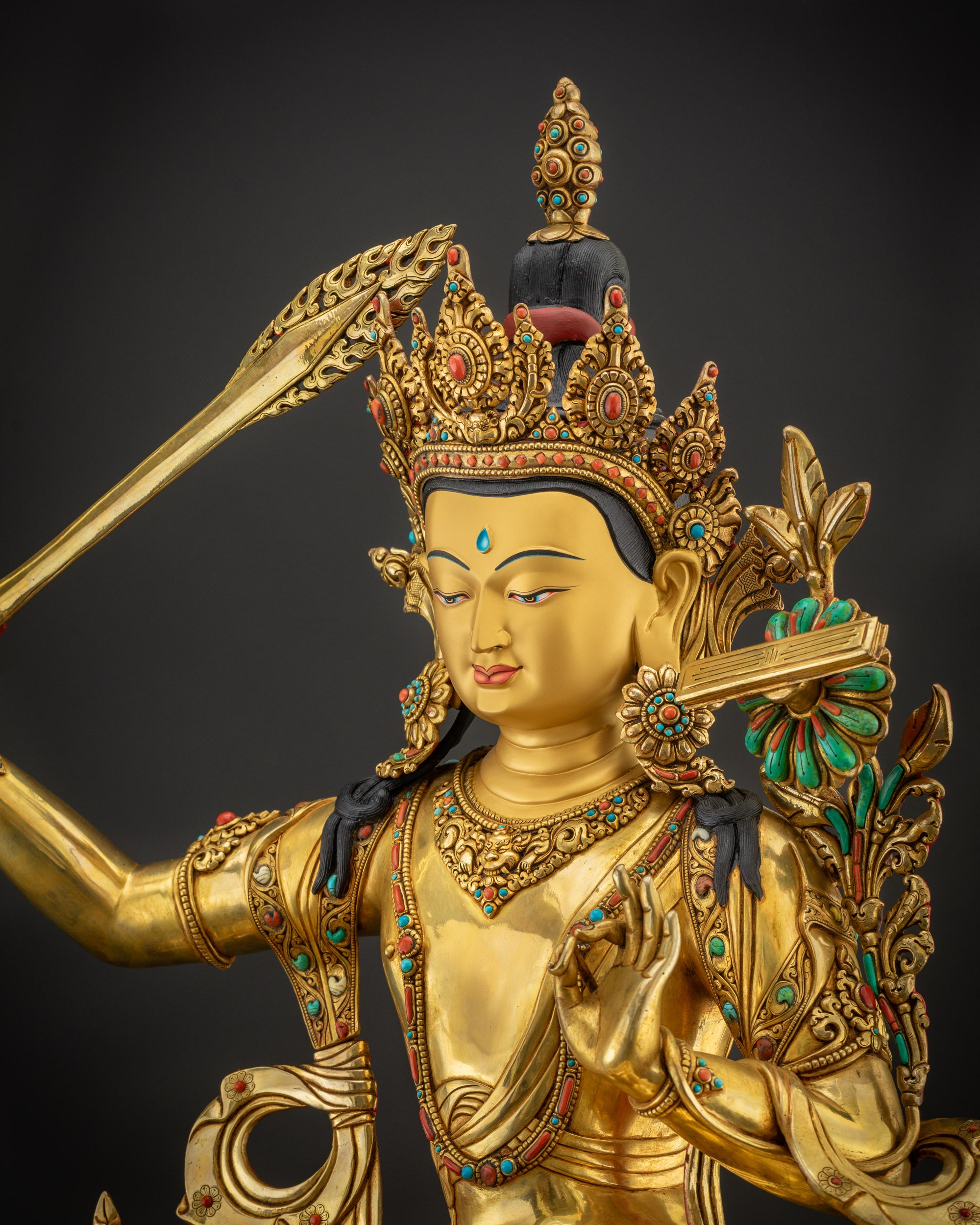 detailed side view Manjushri sculpture flowing robes intricate Tibetan patterns
