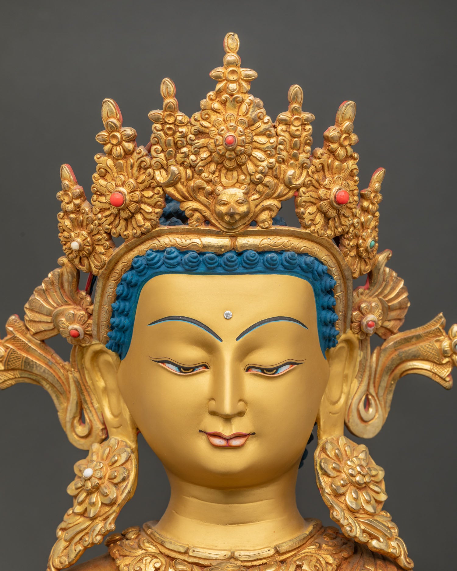 Dipankara Buddha statue detailed close up of gold painted face with serene enlightened expression