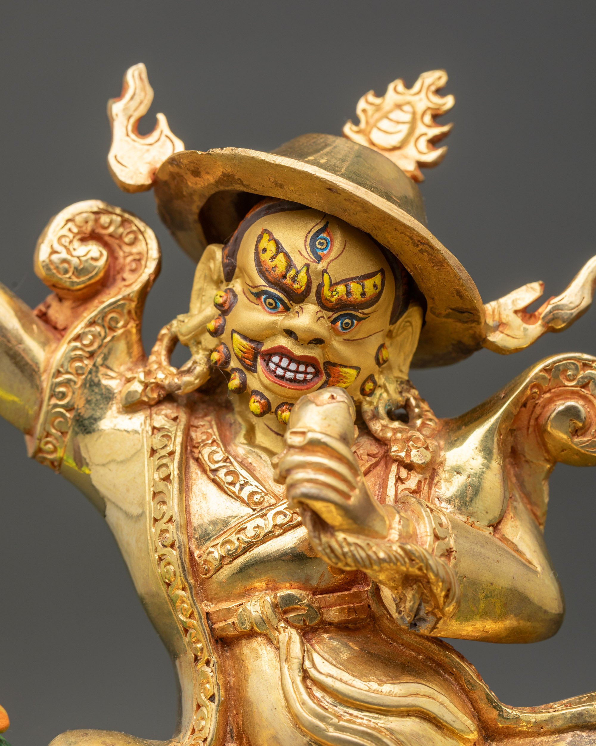 dorje-legpa-statue-close-up-gold-painted-face-wrathful-gaze-handcrafted-patan-nepal