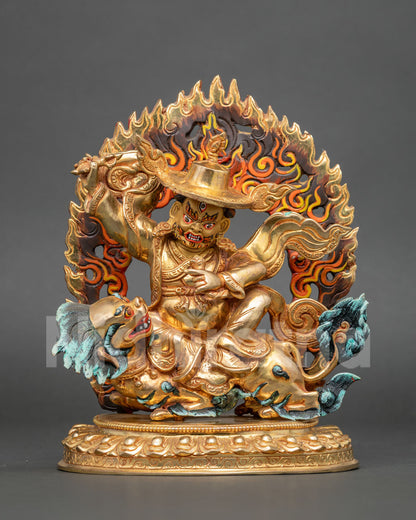 Dorje Legpa statue seated on a snow lion holding a vajra with gold-gilded details