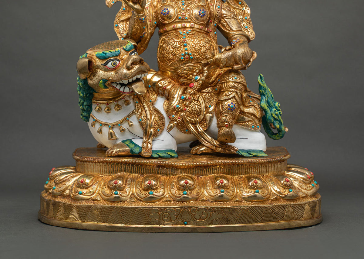 down close up of Namtoshe statue showing gold armor, mongoose and hand-inlaid turquoise and coral