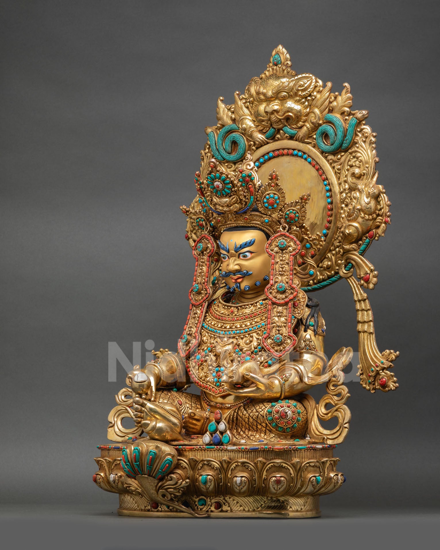 Dzambhala Buddhist statue decorated halo Garuda motifs semi precious stones radiant flame aureole Himalayan sacred art
