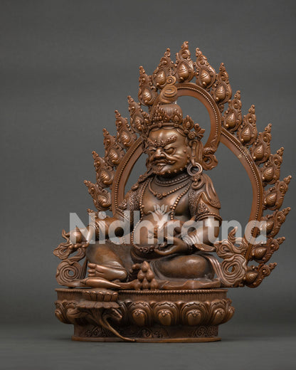 Dzambhala Buddhist statue with flaming aureole and intricate scrollwork details