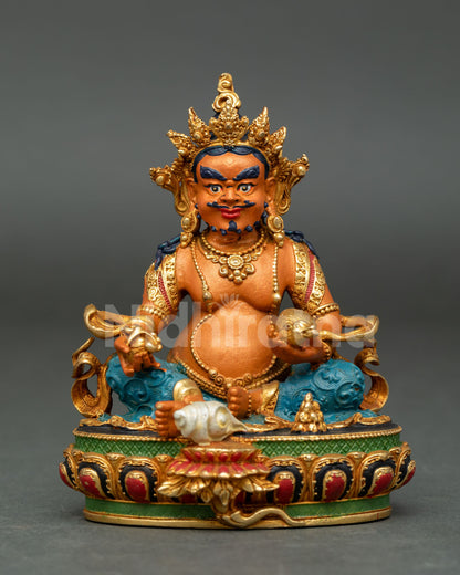 Dzambhala Buddhist wealth statue featuring lotus throne conch shell support and sacred symbols of prosperity and generosity.