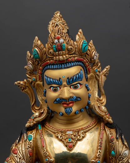 Dzambhala face close up gold painted wrathful compassionate expression five jeweled crown semi precious stone details