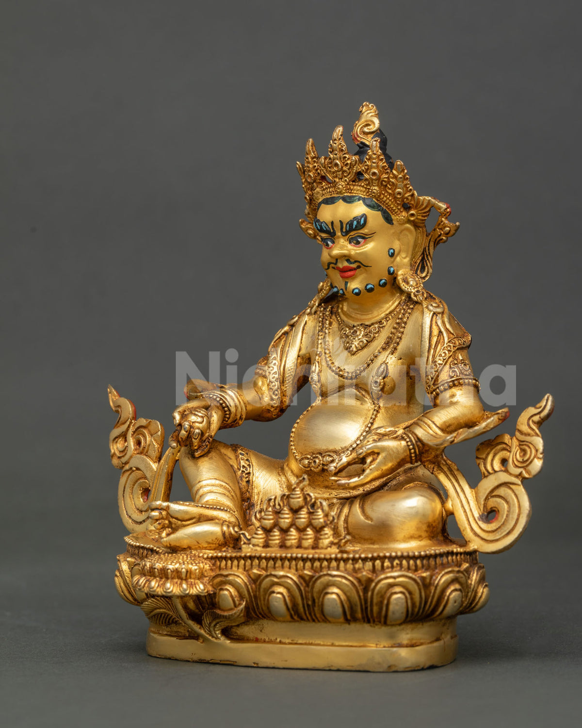 Dzambhala holding citron fruit with jewel spitting mongoose in traditional nepalese buddhist art.