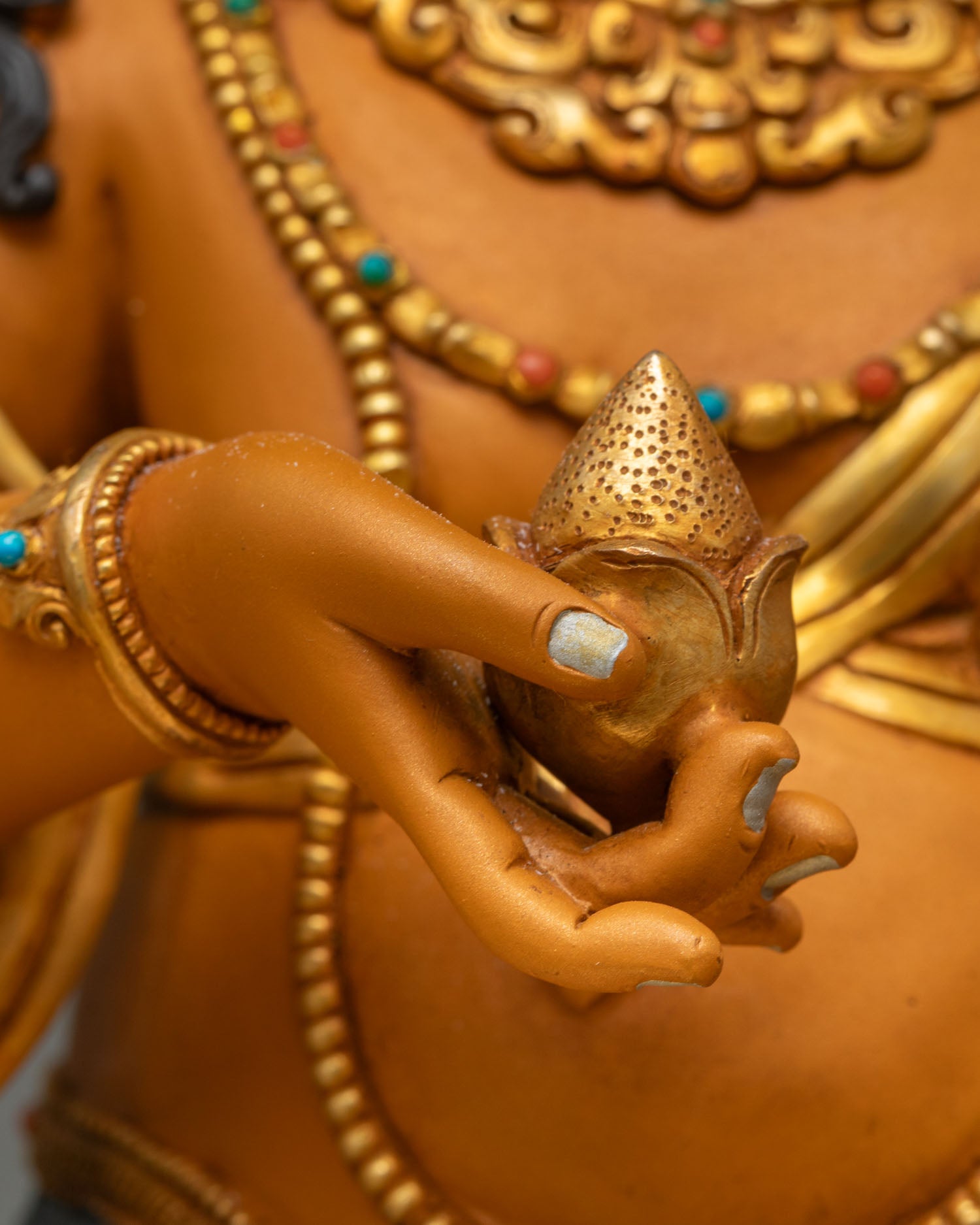 Dzambhala holding jewel-spitting mongoose close-up wealth deity Himalayan Buddhist art