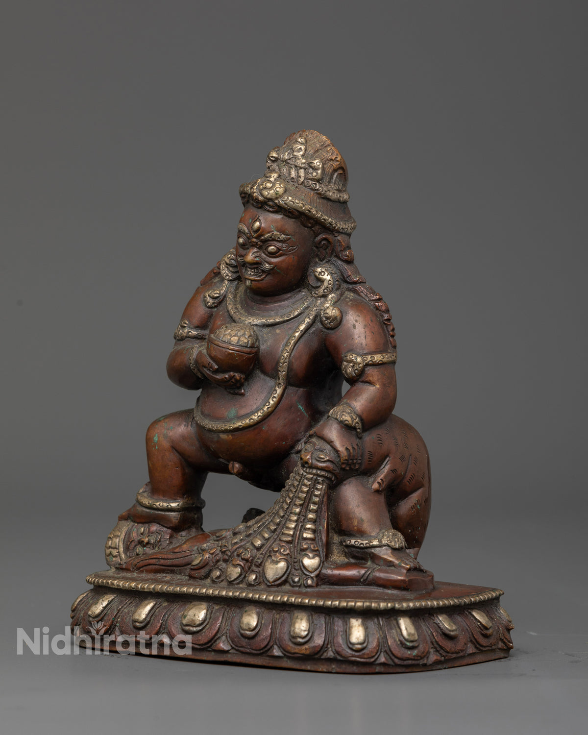 Dzambhala holding skull cup and treasure spitting mongoose.