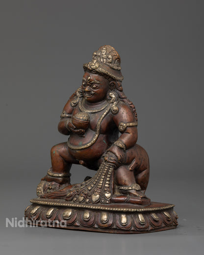 Dzambhala holding skull cup and treasure spitting mongoose.