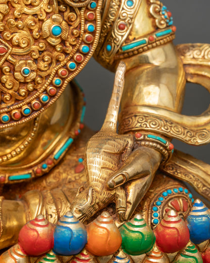 Dzambhala left hand detail mongoose nakula turquoise inlay gold copper close-up