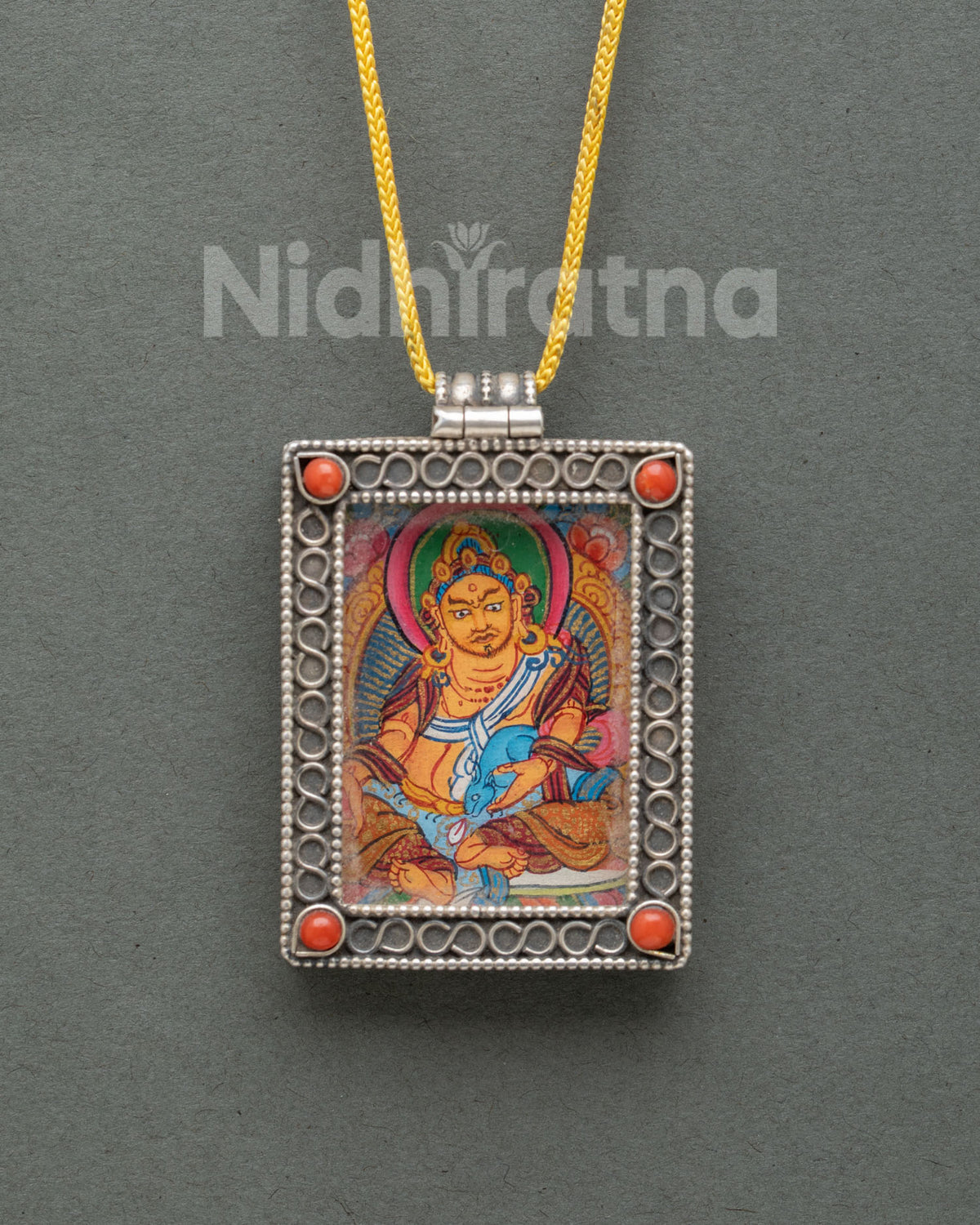 Dzambhala silver Buddhist locket featuring a miniature hand-painted Shakyamuni Buddha thangka on cotton canvas with acrylic paints.