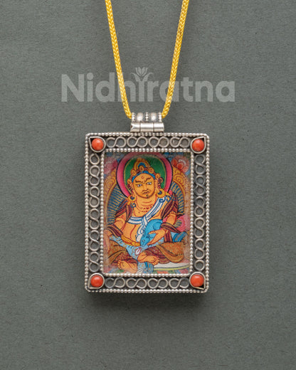 Dzambhala silver Buddhist locket featuring a miniature hand-painted Shakyamuni Buddha thangka on cotton canvas with acrylic paints.