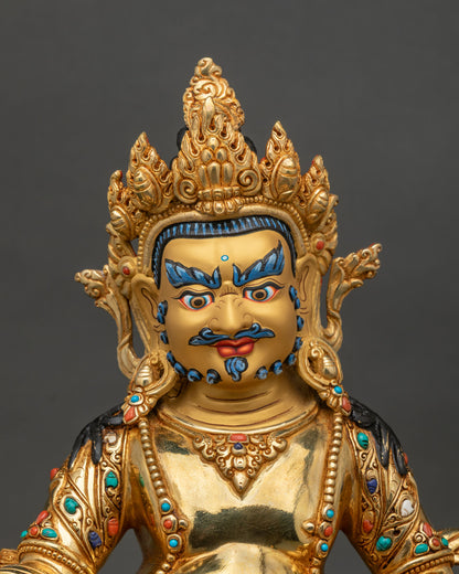 Dzambhala statue 24K gold painted face adorned with semi precious stones.