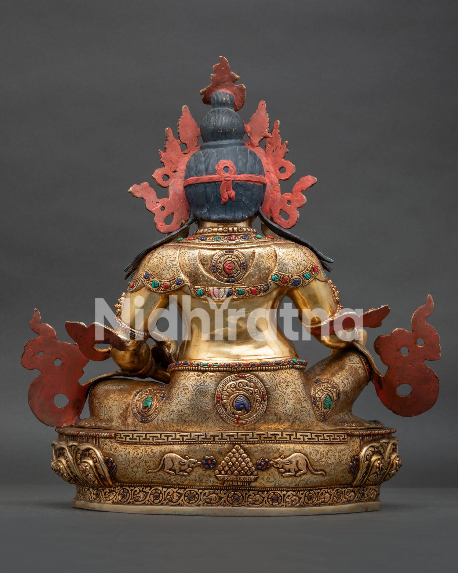 dzambhala statue back view lotus pedestal cintamani design mice motifs