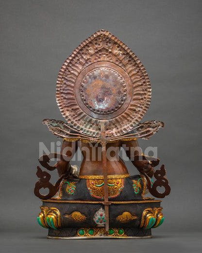 Dzambhala Statue back view with hammered copper halo, oxidized robe and carved mongoose base