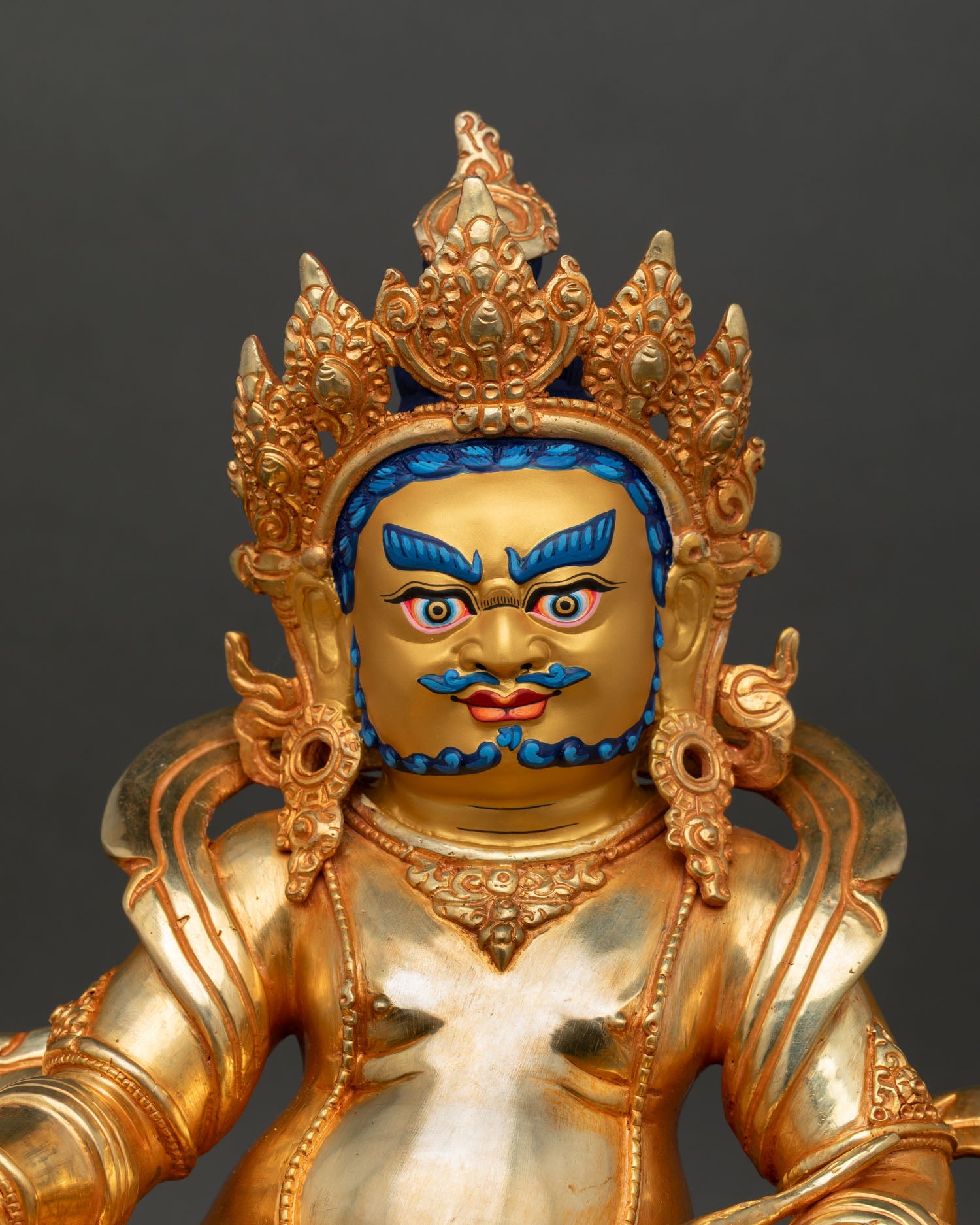 Dzambhala statue close-up detail, mongoose releasing jewels, citron fruit ornaments, jeweled crown, 24K gold Buddhist art