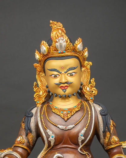 Dzambhala Statue close up of lotus pedestal with citron fruit, jeweled mongoose and gold-gilded details