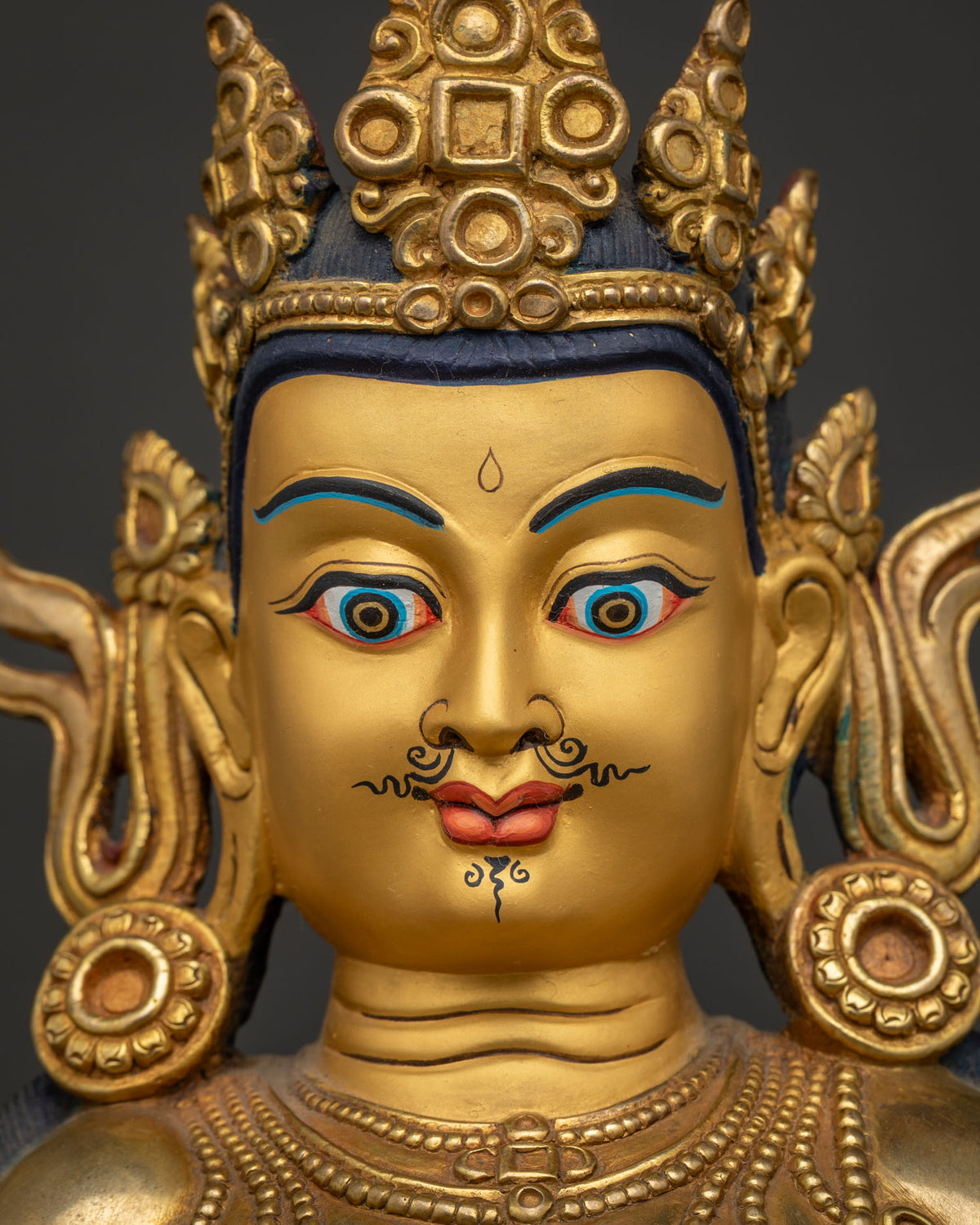 Dzambhala Statue detailed face close up, semi-wrathful expression with piercing eyes