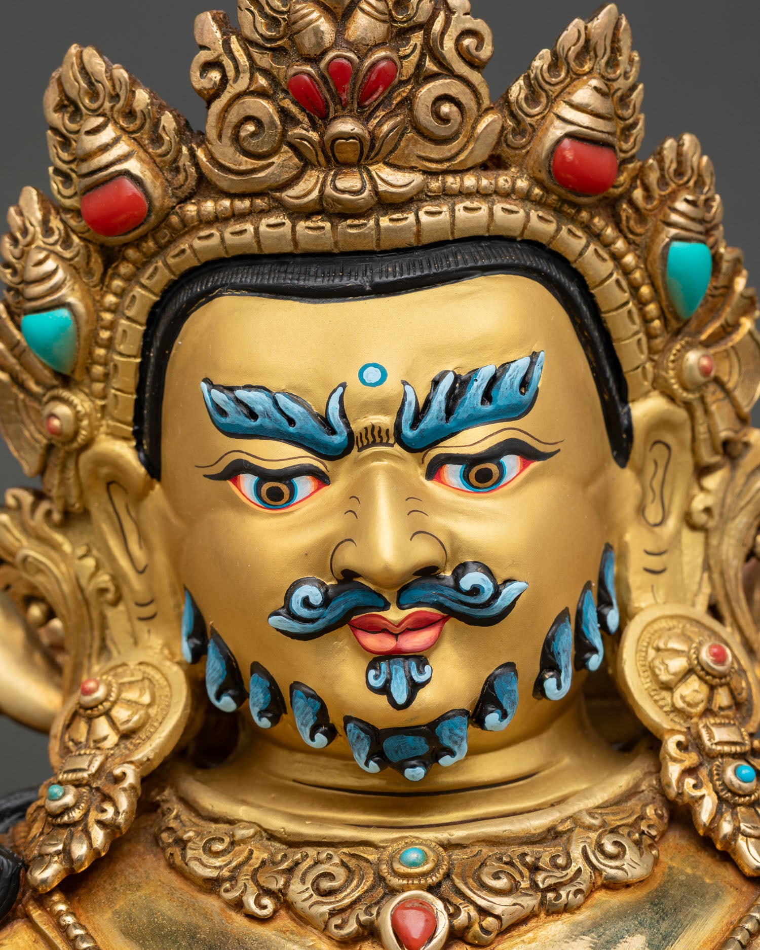 Dzambhala Statue Face Close Up Serene Gold Painted Face Buddhist Wealth Deity