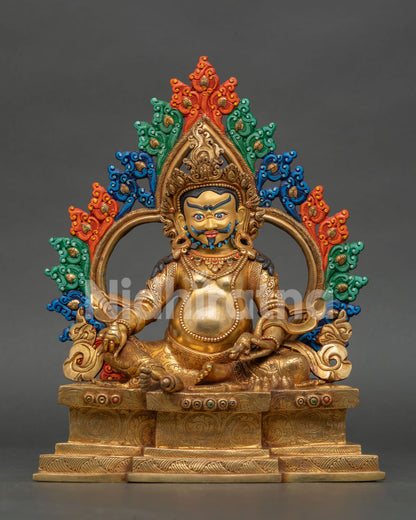 Dzambhala statue from Nepal with gold gilded copper body, jeweled details, and ornate throne
