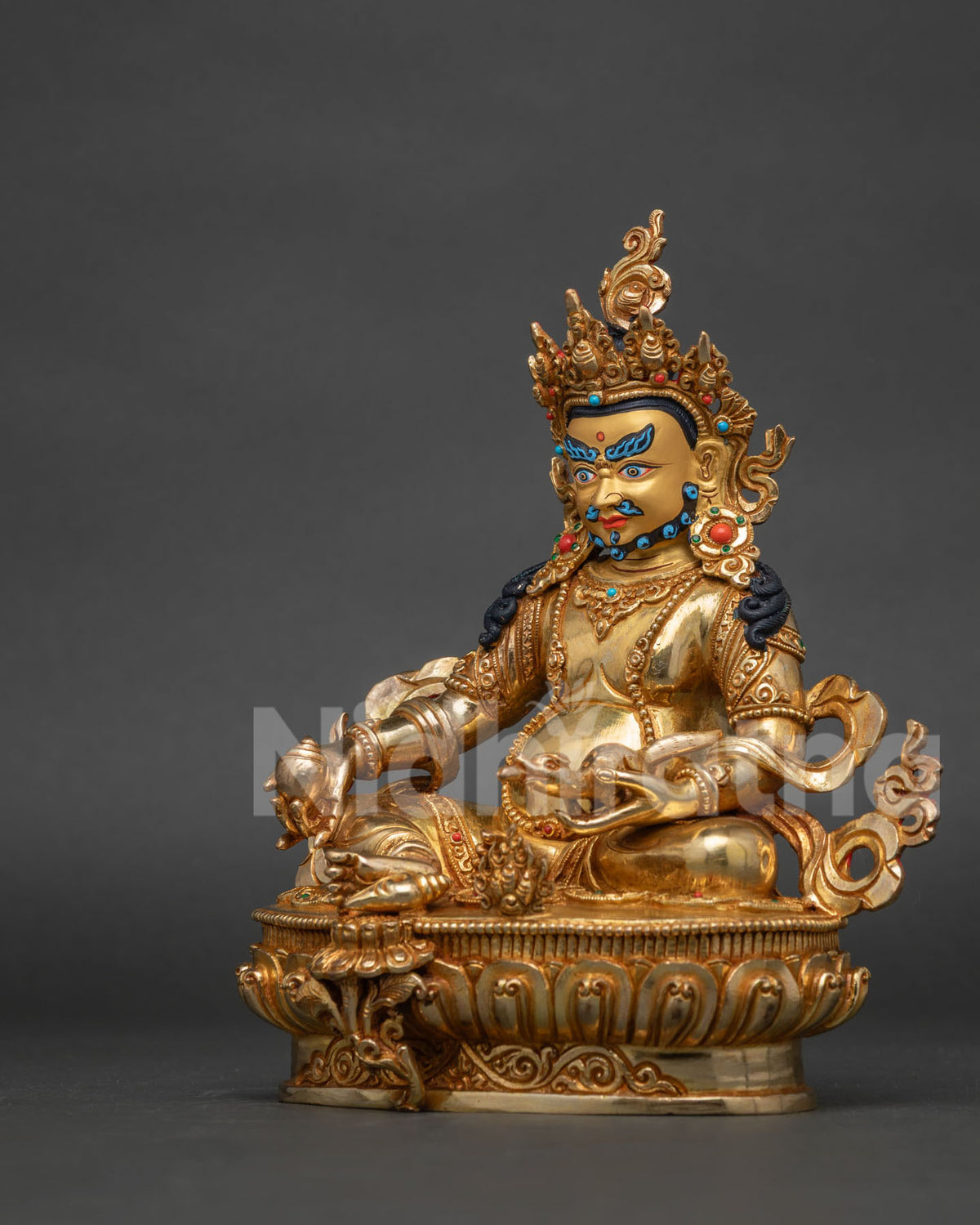 Dzambhala statue from patan nepal with semi precious stones and intricate newari craftsmanship.