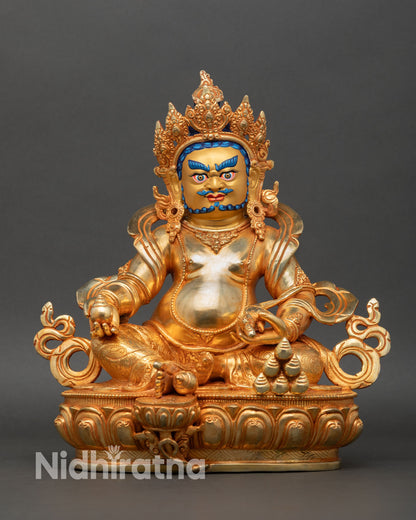 Dzambhala statue front view gold gilded copper wealth deity seated lotus pedestal Nepal Newari artisan lost wax casting