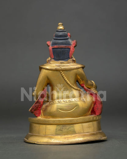 Dzambhala statue gold fire gilded copper Buddhist wealth deity back view.