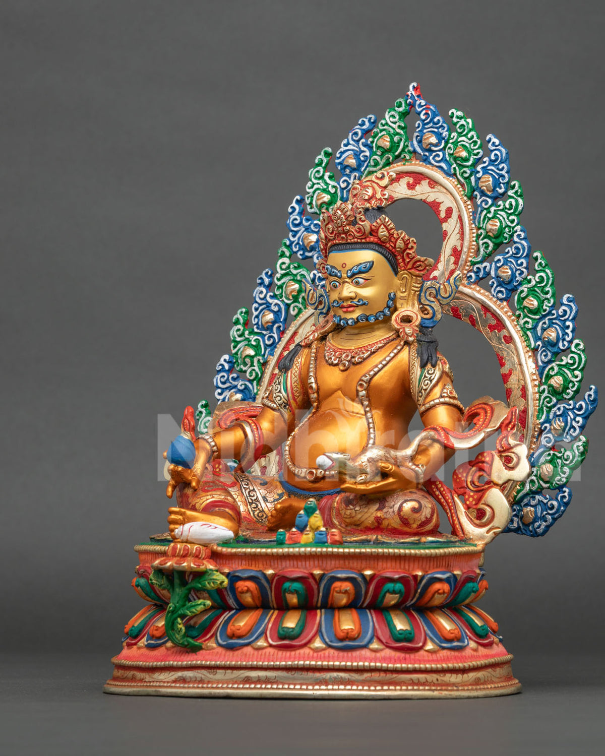 Dzambhala statue hand carved floral halo and multicolor lotus pedestal detail view.