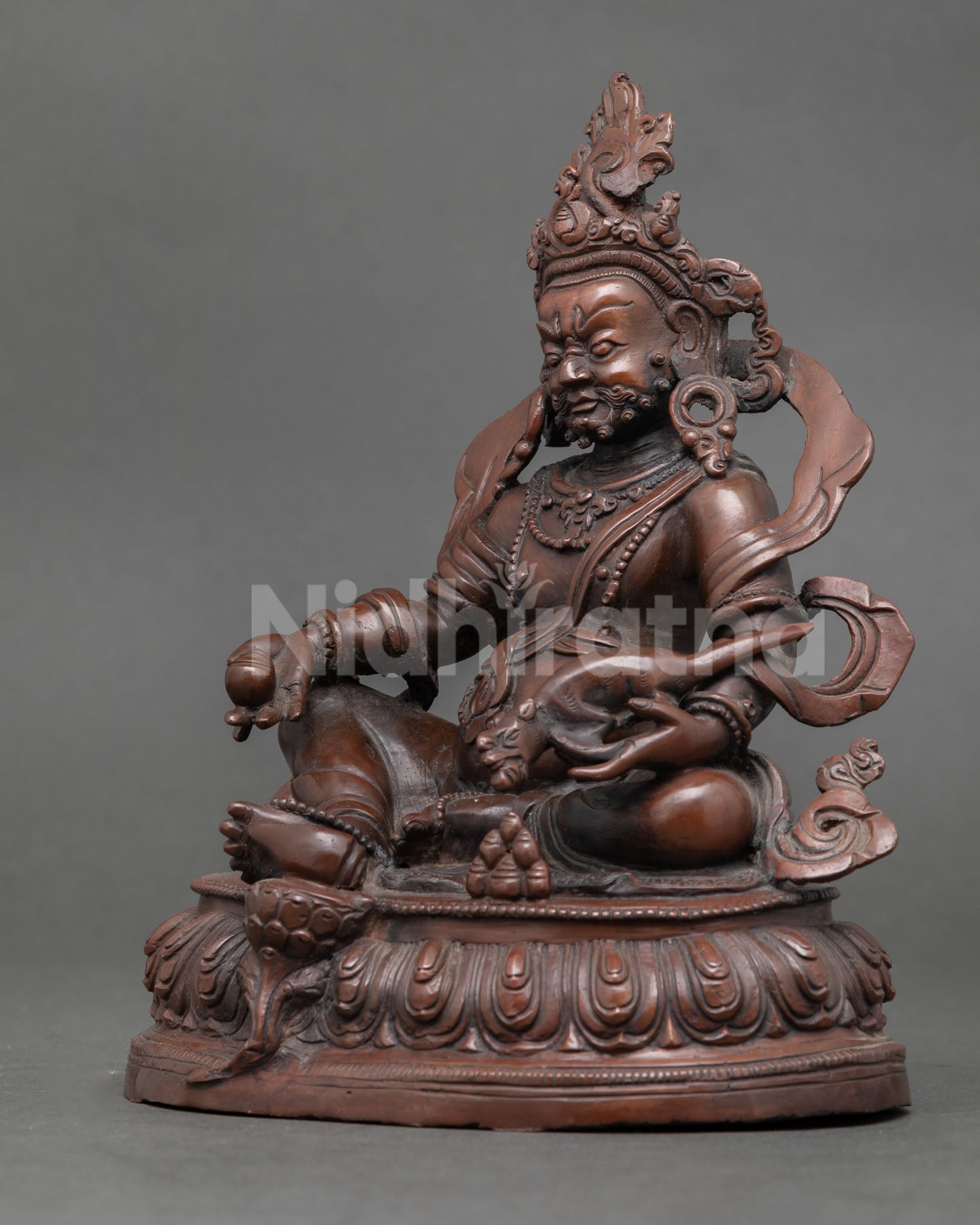 Dzambhala statue handcrafted by Newari artisan from Patan Nepal with oxidized copper finish and lotus pedestal.
