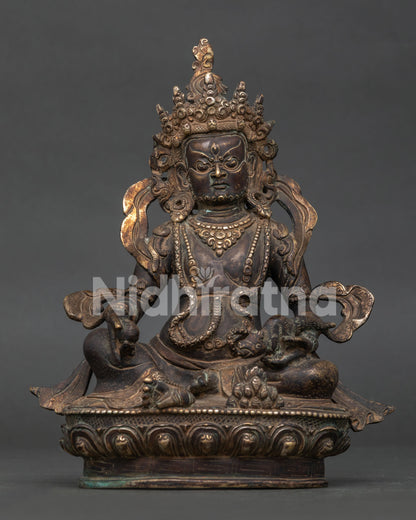 Dzambhala statue handcrafted by Newari artisans in Patan Nepal with oxidized copper finish.