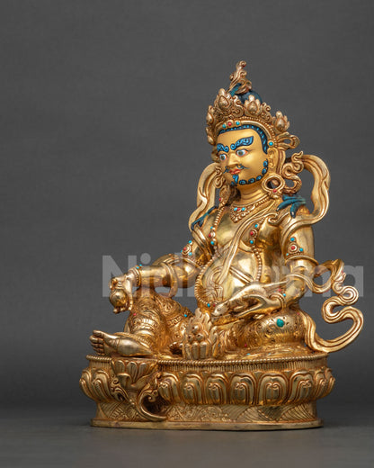 Dzambhala statue holding Chintamani jewel and jewel spitting mongoose.