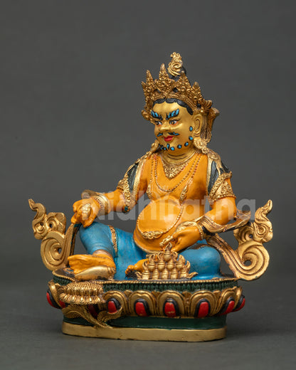Dzambhala statue holding jewel spitting mongoose for wealth and prosperity.