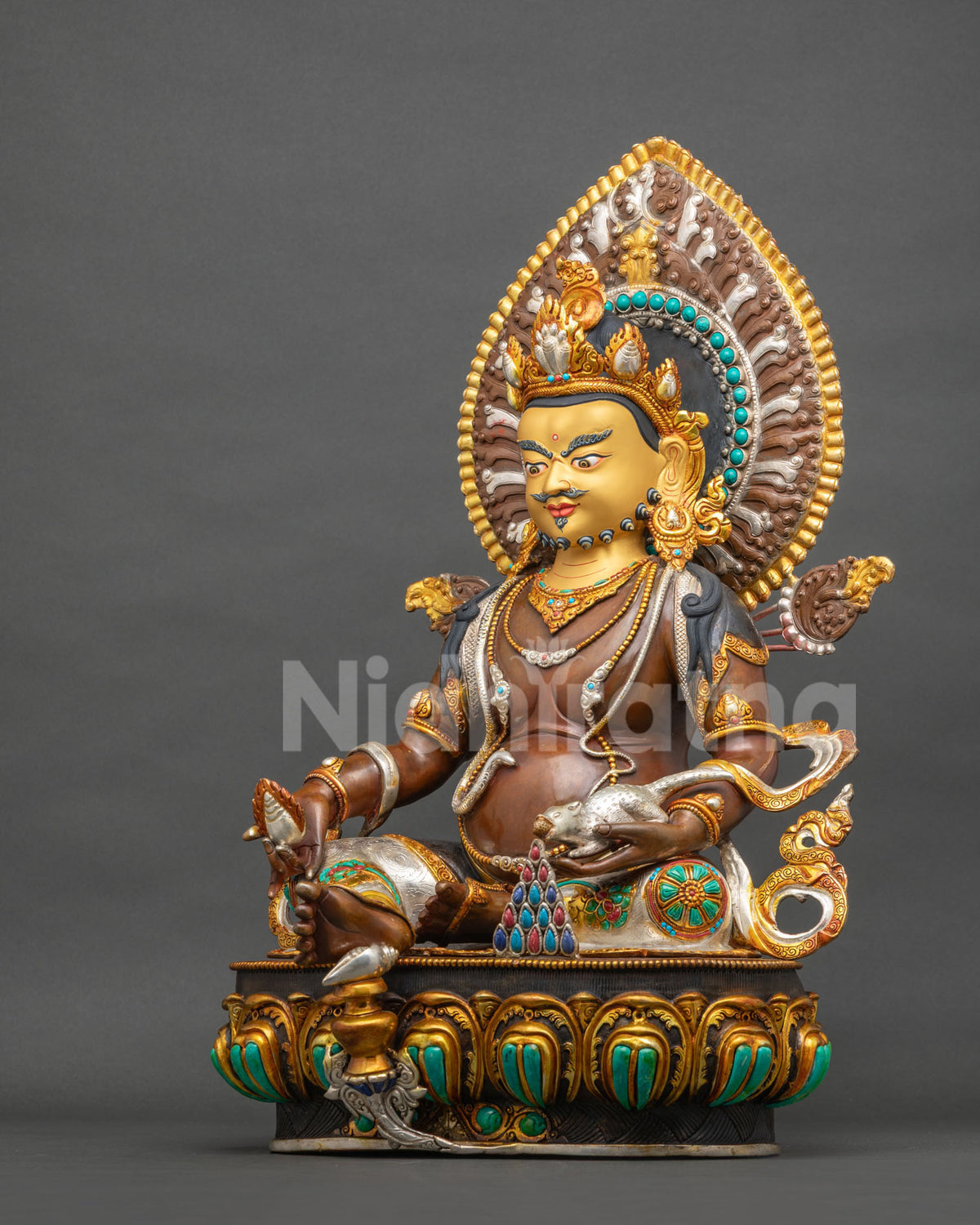 Dzambhala Statue left side view showing oxidized copper body, lotus pedestal and gold-gilded ornaments