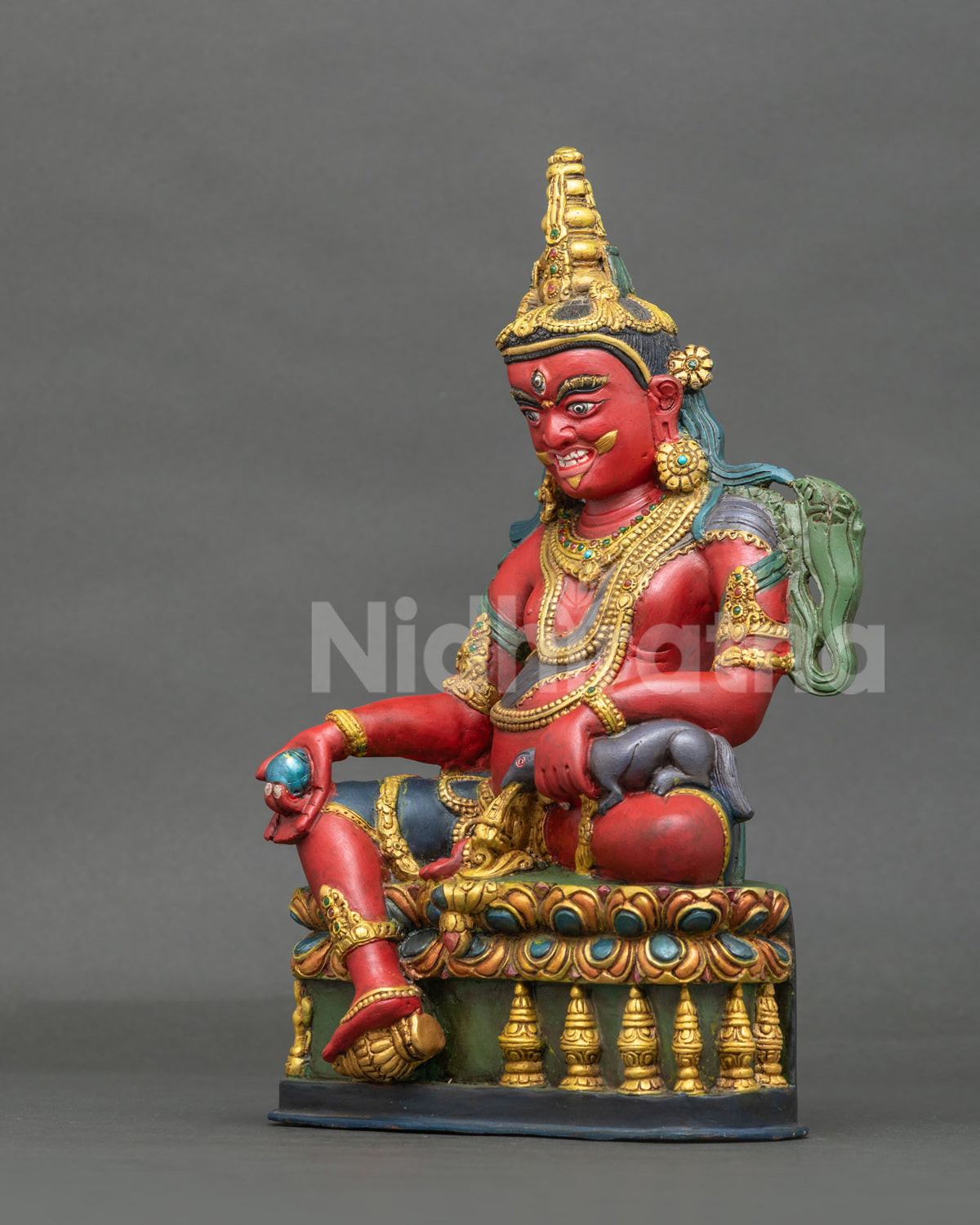 Dzambhala Statue left view hand carved lotus pedestal gold gilded details.