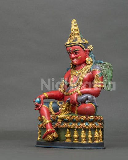 Dzambhala Statue left view hand carved lotus pedestal gold gilded details.