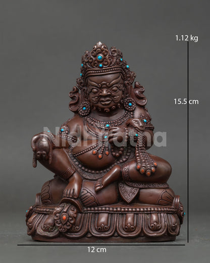 Dzambhala statue in oxidized copper with semi precious stones and lotus pedestal.