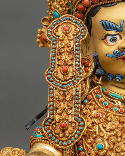 Dzambhala statue right earring close-up hand-set coral turquoise gold ornament Nepal