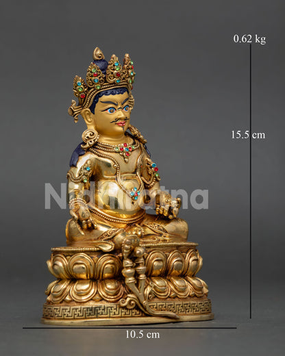 Dzambhala statue seated on a double lotus pedestal holding mongoose and citron fruit symbols of wealth and prosperity.